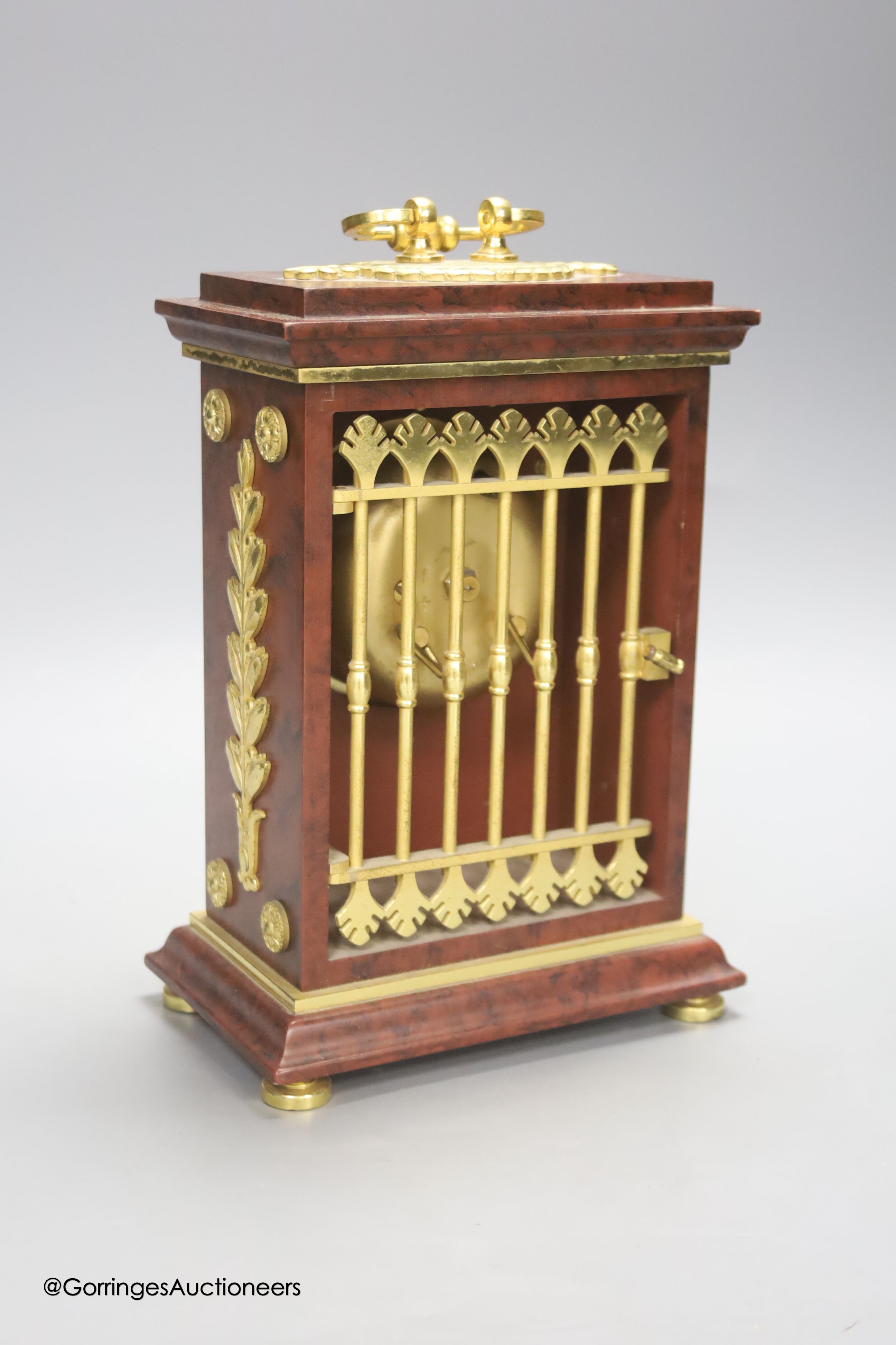 A Le Castel faux marble mantel clock, height 24cm